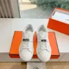 Hermès Women White Low-Top Sneakers — Silver-Tone Buckle Detail product view 1