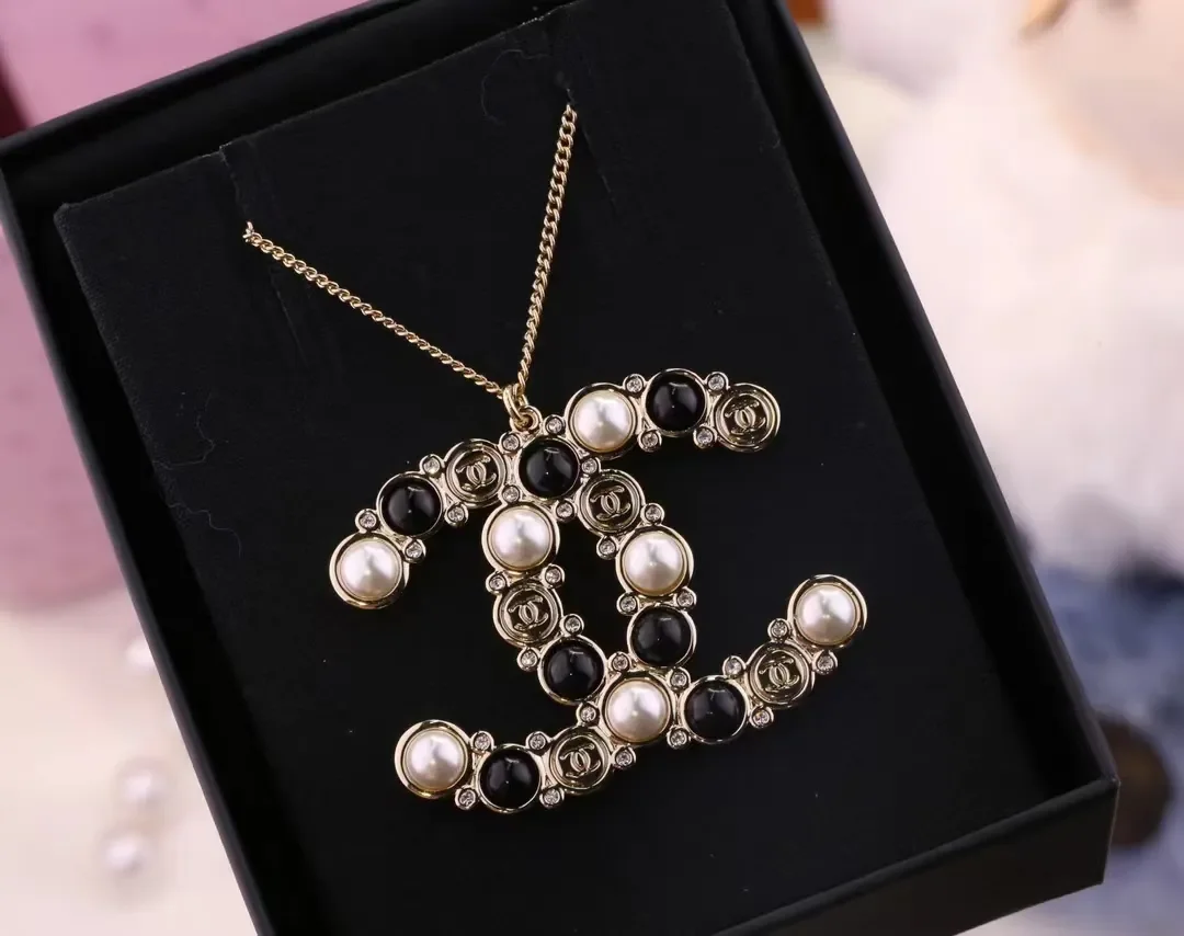 Chanel Oversized Pearl-Effect CC Pendant Necklace Black and Gold-Tone product view 1